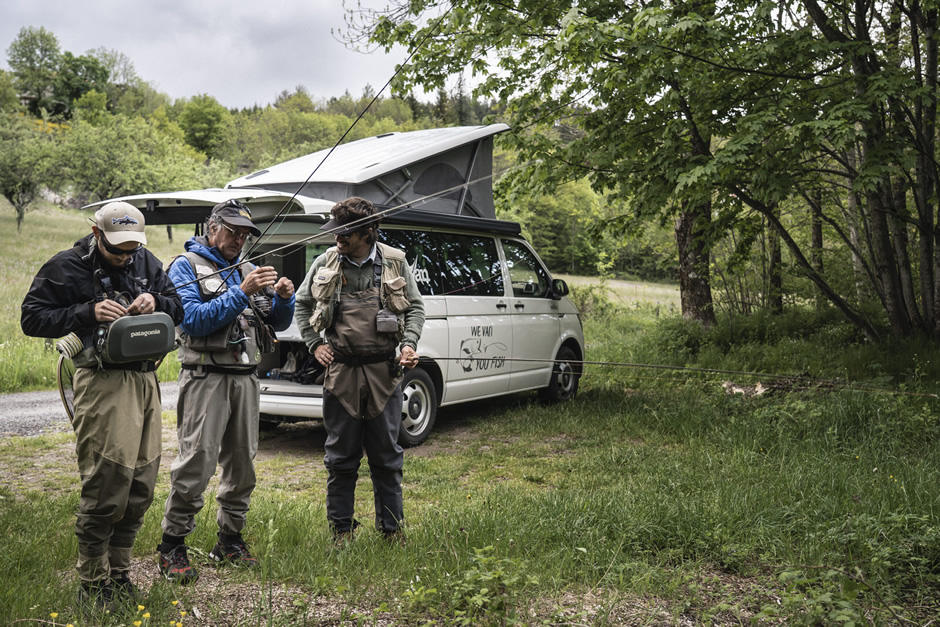 Three men are getting ready to fly fish