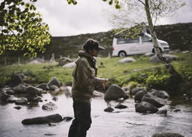 Man fishing near his camper van