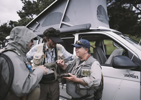 Friends are talking during fishing trip