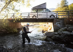 Man during his camper van fishing trip