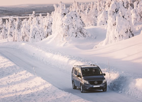 A 9-passenger minibus driving in the mountains