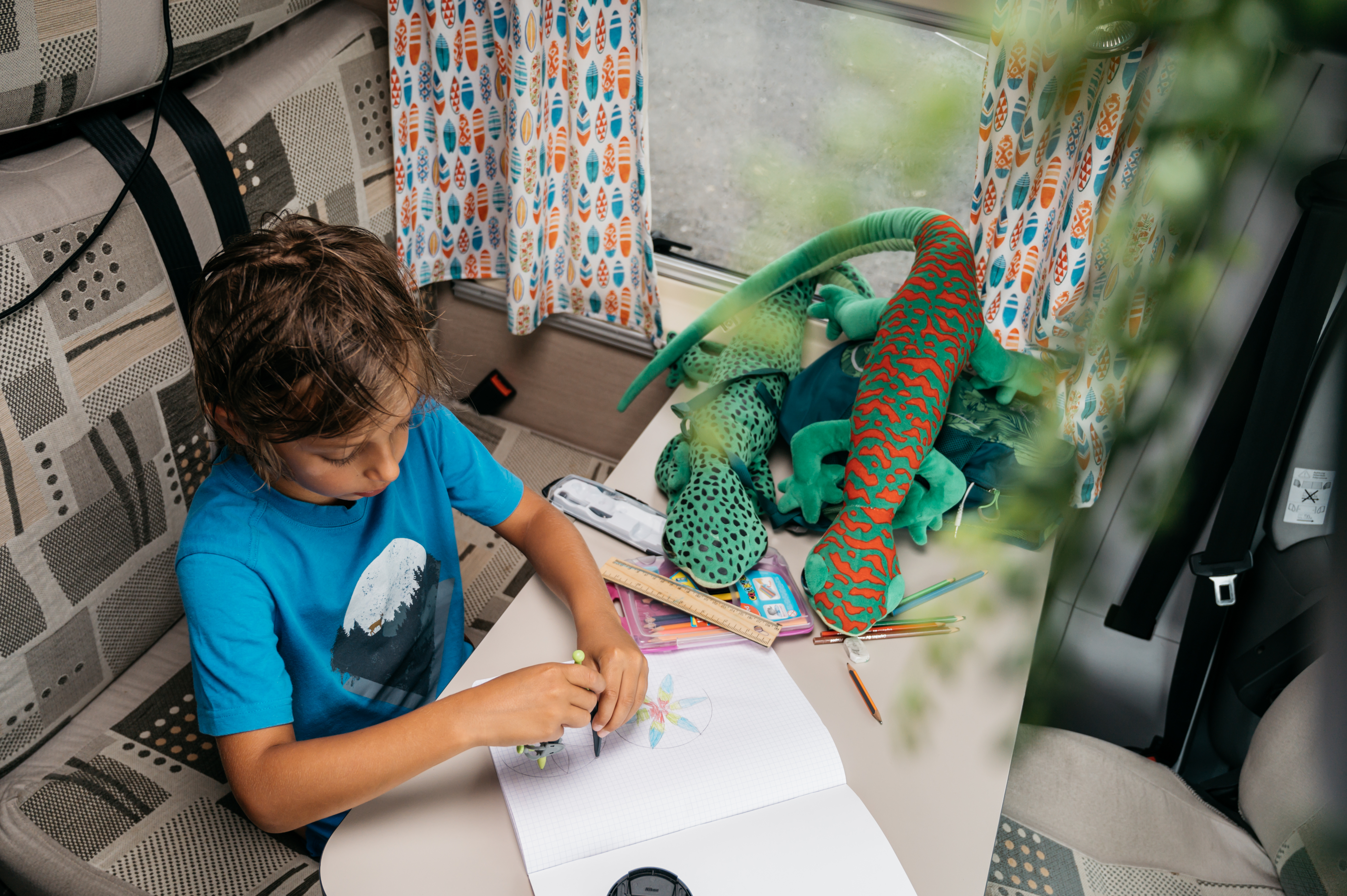 Enfant dessinant à l'intérieur d'un van aménagé